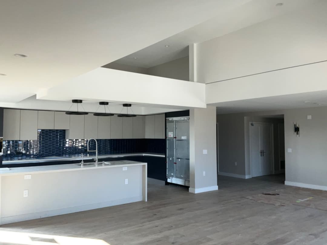 Spacious modern kitchen with island and open layout in a new home interior.